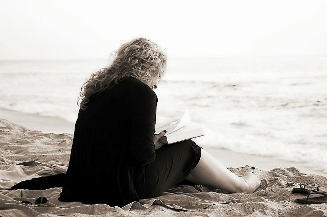 Thanks to makunin via Pixabay.com for this picture. [Picture of woman on a beach reading a book